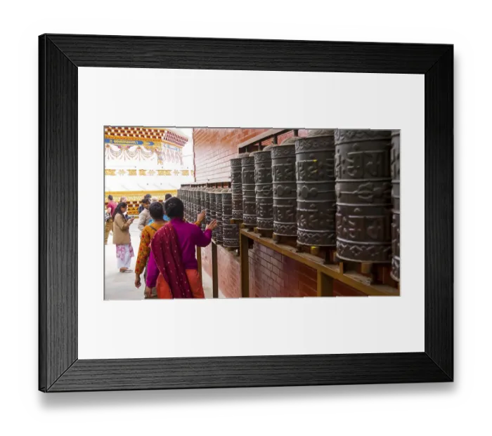 Framed Print : People turn the prayer wheels in a Buddhist temple and create a spiritual atmosphere