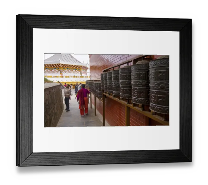 Framed Print : People interact with prayer wheels in a Buddhist-decorated temple with a red and gold accent Framed Print : People interact with prayer wheels in a Buddhist-decorated temple with a red and gold accent