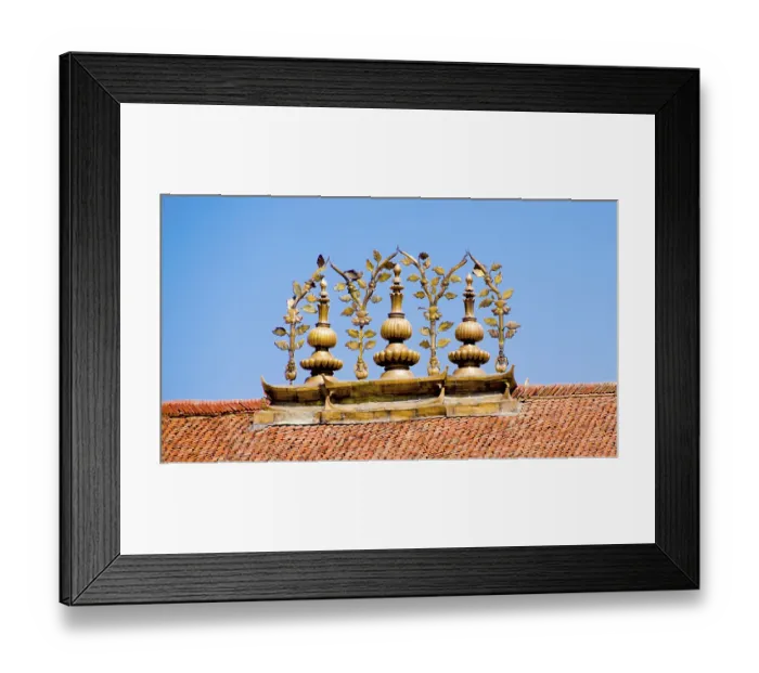 Framed Print : Golden Buddhist ornaments decorate a roof under a blue sky