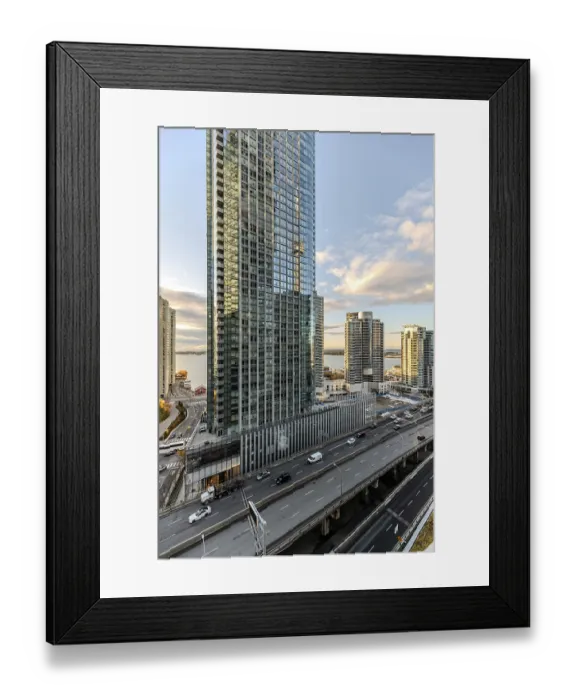 Framed Print : A modern city view featuring skyscrapers and a busy road under a colorful sunset in Toronto Framed Print : A modern city view featuring skyscrapers and a busy road under a colorful sunset in Toronto