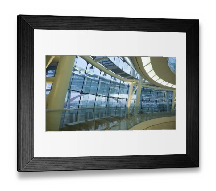 Framed Print : Futuristic atrium environment, glass wall and metallic construction inside big public hall with sitting man