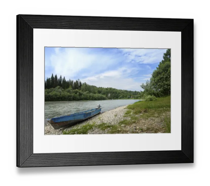 Framed Print : Daytime landscape with a mountain river among coniferous forest with a motorboat on a rocky shore