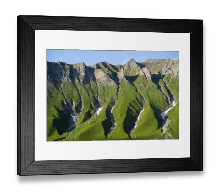 Framed Print : Distinctive rocky ridges with green vegetation under clear Framed Print : Distinctive rocky ridges with green vegetation under clear