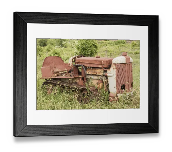 Framed Print : Old neglected rusty small vintage caterpillar tractor on green meadow