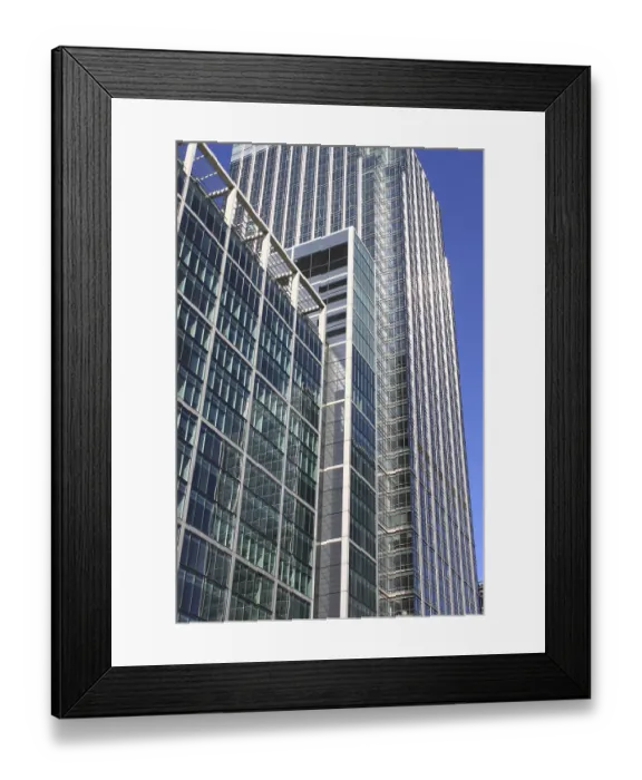 Framed Print : Modern glass skyscraper on a blue sky background Framed Print : Modern glass skyscraper on a blue sky background