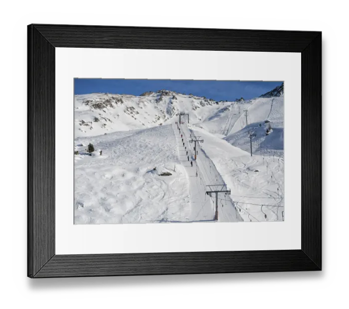 Framed Print : Ski resort in the Swiss Alps. Skiers ascend on rope tow up Framed Print : Ski resort in the Swiss Alps. Skiers ascend on rope tow up
