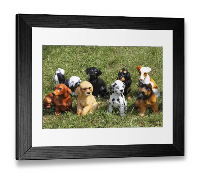 Framed Print : Dog breed statues on a grass background