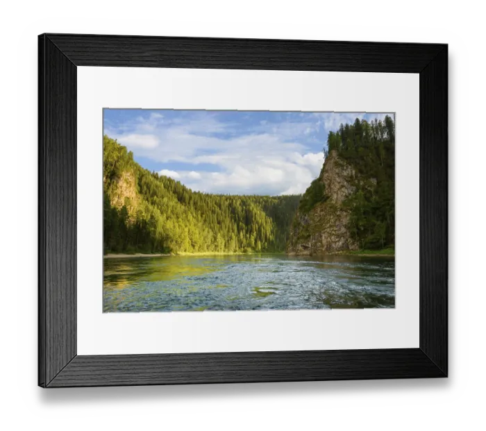 Framed Print : A river among a coniferous forest