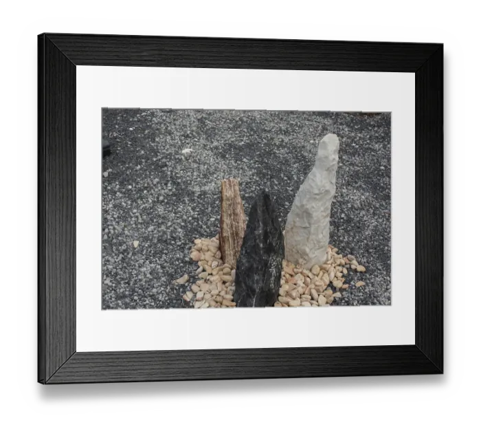 Framed Print : Three colorful standing stones arranged in a circle of pebbles on a grey gravel background Framed Print : Three colorful standing stones arranged in a circle of pebbles on a grey gravel background