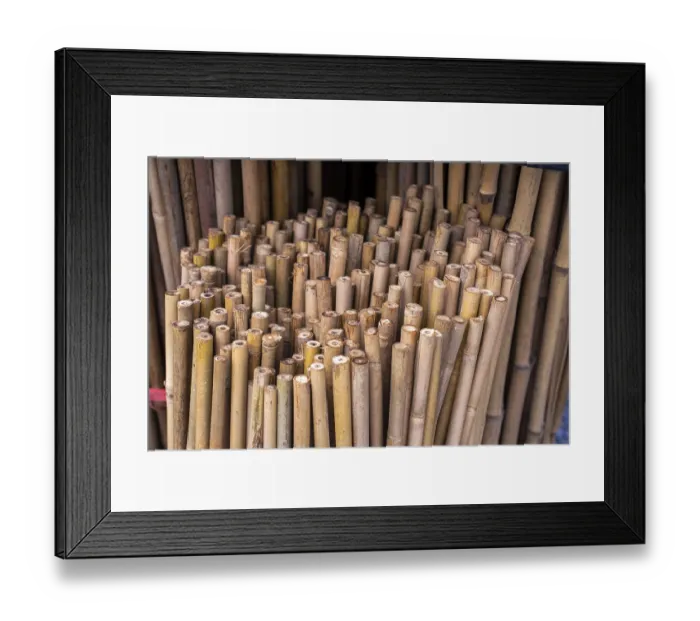 Framed Print : Close up full frame texture of vertical dry brown bamboo poles arranged as a natural fence
