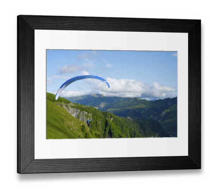 Framed Print : Paraglider flying with blue sky and mountain scenery Framed Print : Paraglider flying with blue sky and mountain scenery