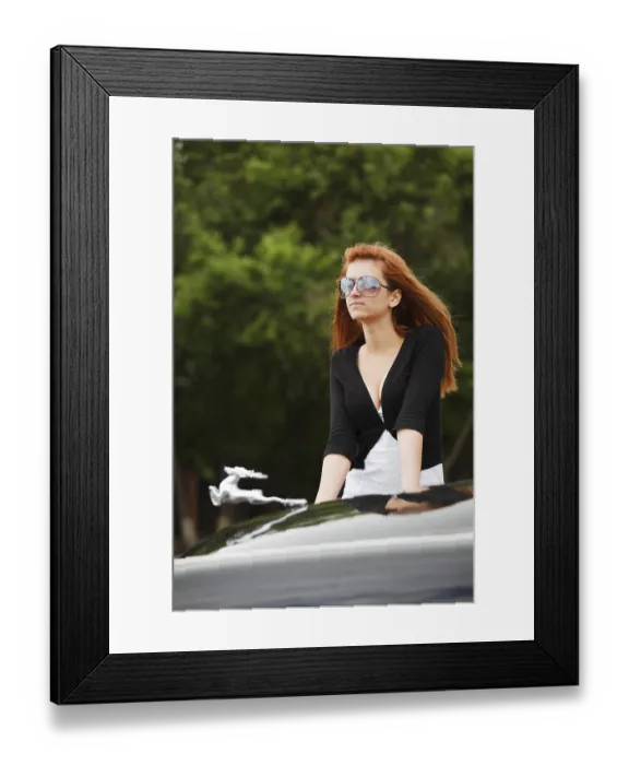 Framed Print : Young woman by the classic car