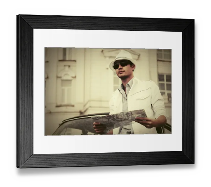 Framed Print : Young fashion man with a road map next to vintage car