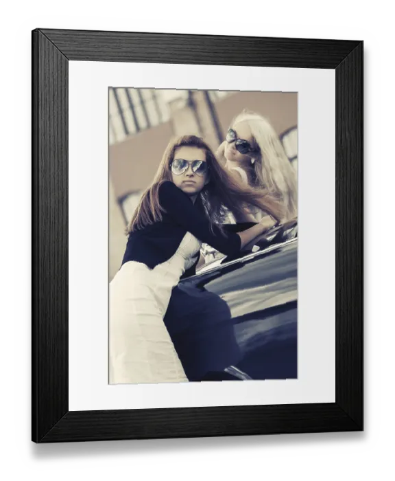 Framed Print : Two young women leaning on the vintage car in city street Framed Print : Two young women leaning on the vintage car in city street