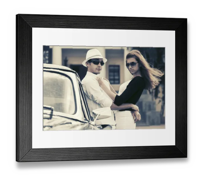 Framed Print : Happy young fashion couple in love outside a vintage car