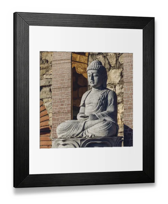 Framed Print : White stone statue of a Buddha on masonry background Framed Print : White stone statue of a Buddha on masonry background