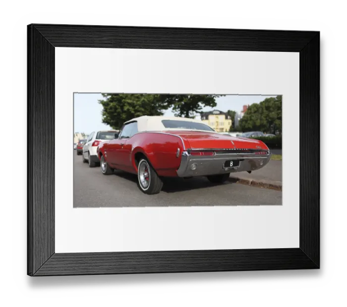 Framed Print : Vintage Olds automobiles on a city street
