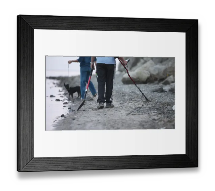 Framed Print : Group of treasure hunters with a dog at work