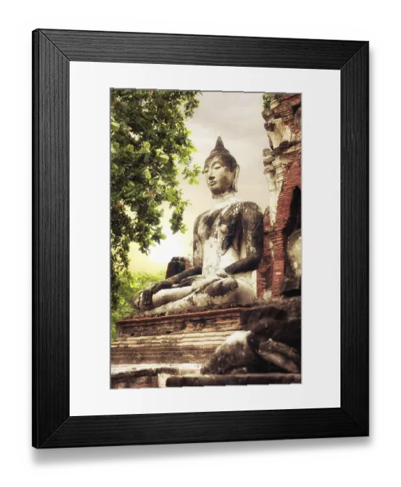 Framed Print : Asian religious architecture. Ancient sandstone sculpture of Buddha at Wat Mahathat ruins under sunset sky