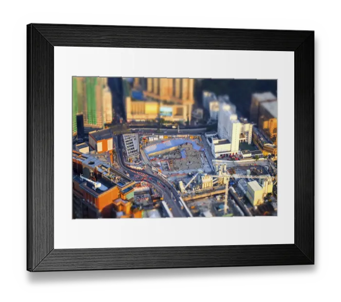 Framed Print : Tilt shift blur effect. Amazing aerial cityscape view with crane working at building construction Framed Print : Tilt shift blur effect. Amazing aerial cityscape view with crane working at building construction
