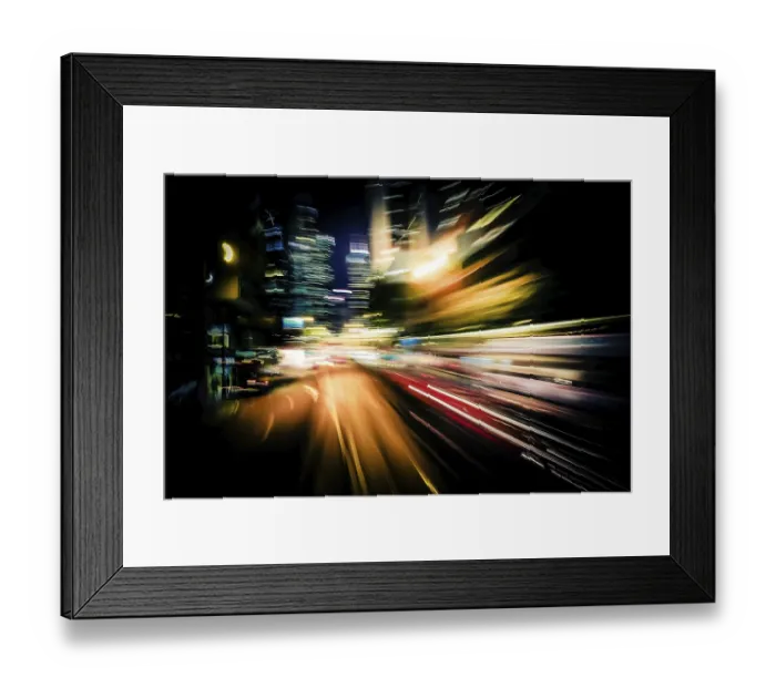 Framed Print : Moving through modern city street with illuminated skyscrapers