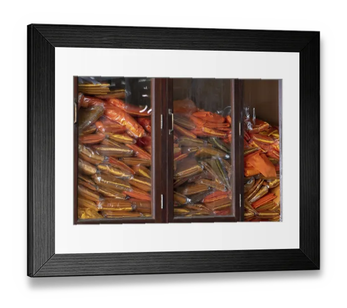 Framed Print : A pile of orange clothes for Buddhist monks in the temple
