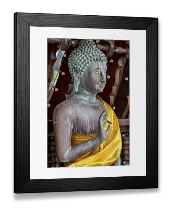 Framed Print : Close-up of a Buddha statue in bronze with a bright yellow cloth