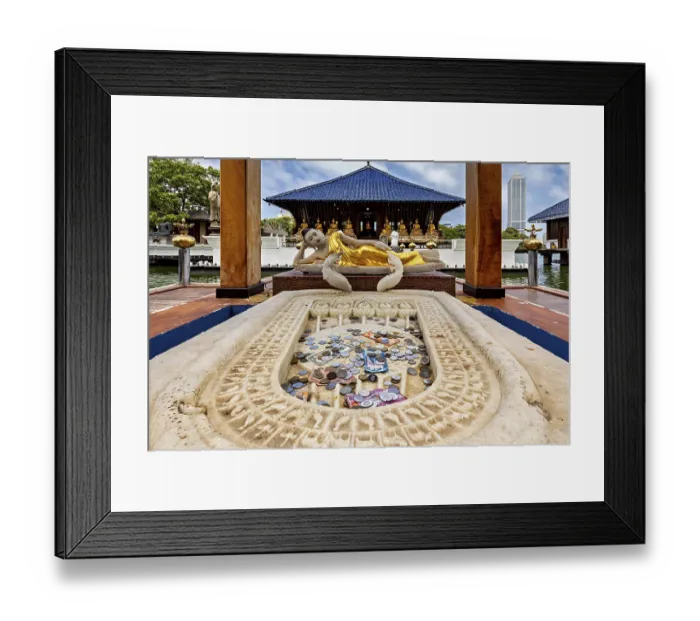 Framed Print : Reclining Buddha statue in a temple with coins in the foreground