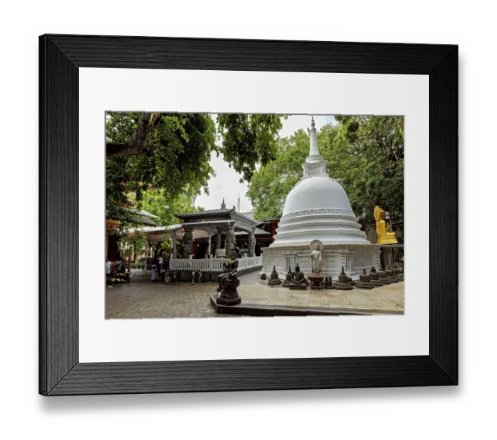 Framed Print : A Buddhist temple complex with a white stupa surrounded by Buddha statues and lush greenery
