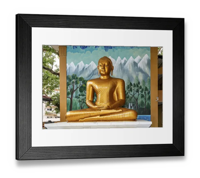 Framed Print : Golden Buddha statue in front of a painted wall with landscape motif Framed Print : Golden Buddha statue in front of a painted wall with landscape motif