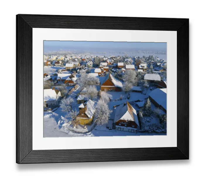 Framed Print : Winter village with snow-covered roofs and half-timbered buildings