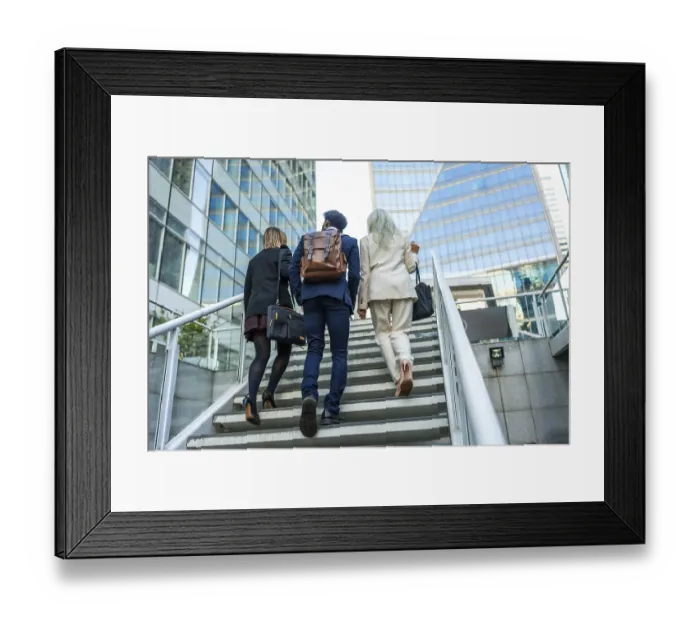 Framed Print : Diverse business colleagues moving upwards on an outdoor staircase in a contemporary city environment