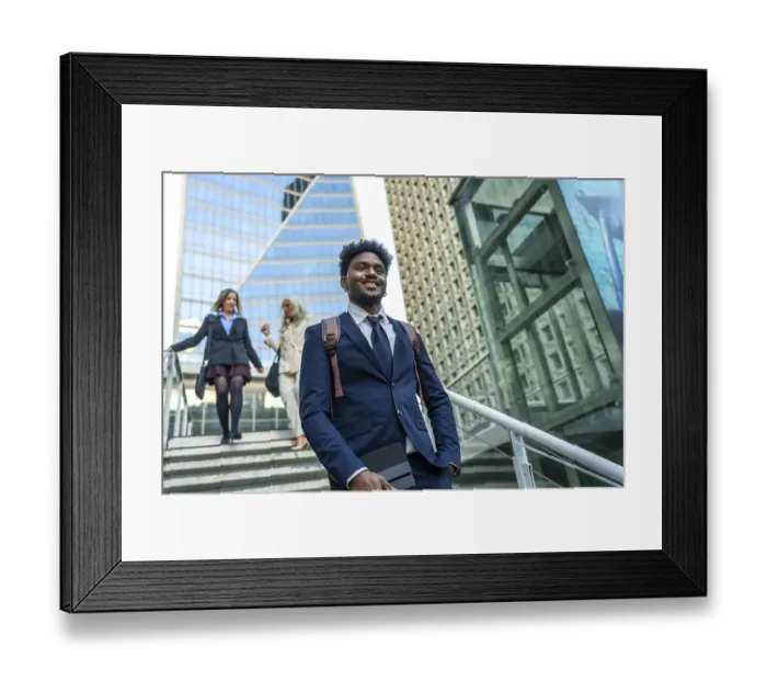 Framed Print : Confident black businessman walking down modern city stairs Framed Print : Confident black businessman walking down modern city stairs