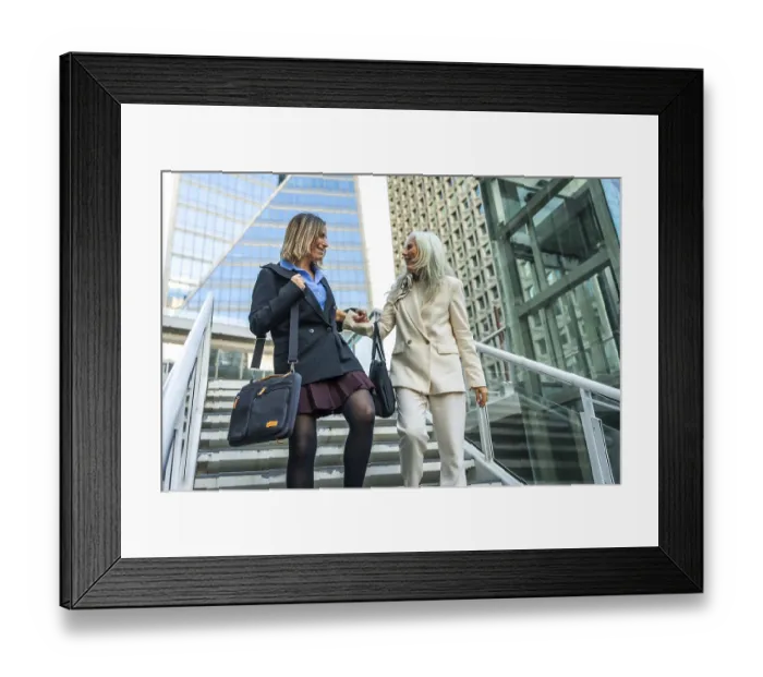 Framed Print : Two businesswomen walk down urban steps