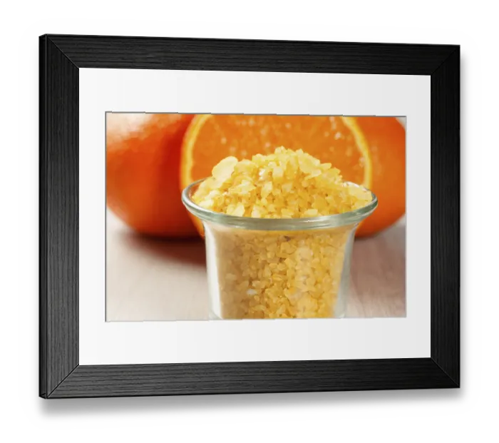 Framed Print : Cut orange and glass bowl with yellow sea salt on wooden desk