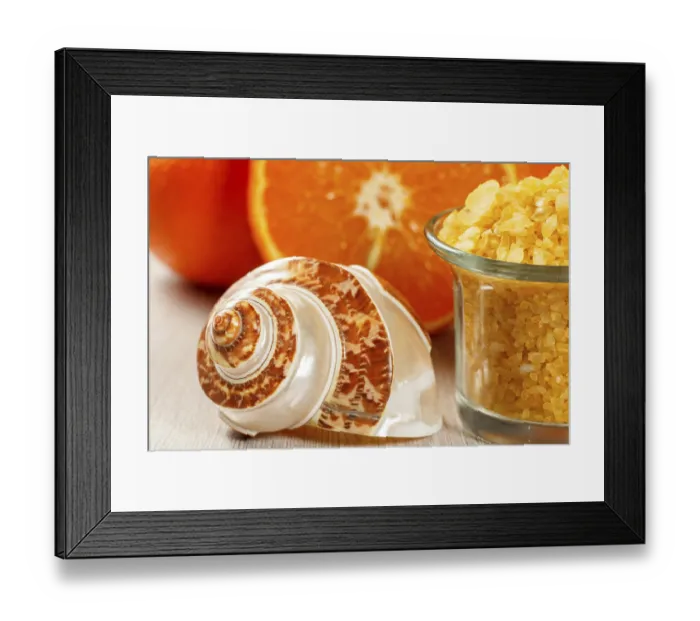Framed Print : Cut orange, sea shell and glass bowl with yellow sea salt on wooden desk