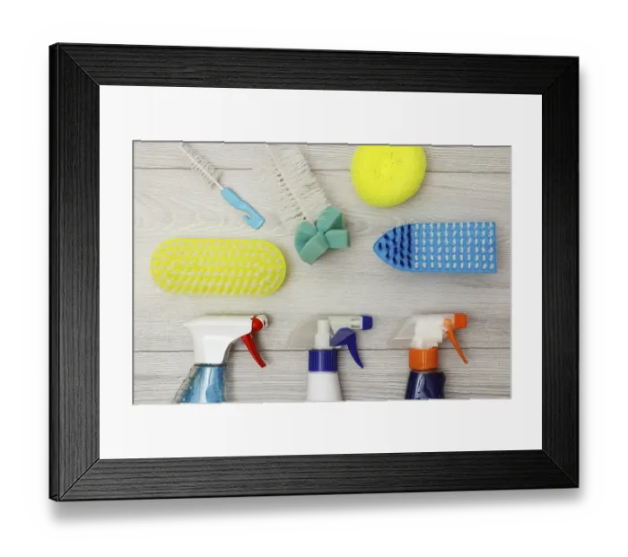 Framed Print : Bottles of detergent, color synthetic sponges for cleaning and dust brushes on gray wooden background