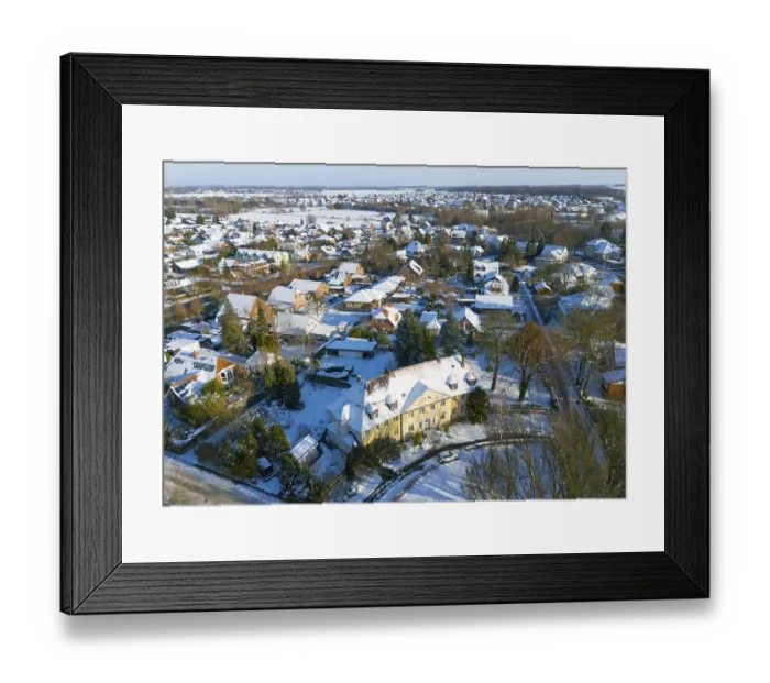 Framed Print : Residential area in winter with snow-covered classic buildings and trees