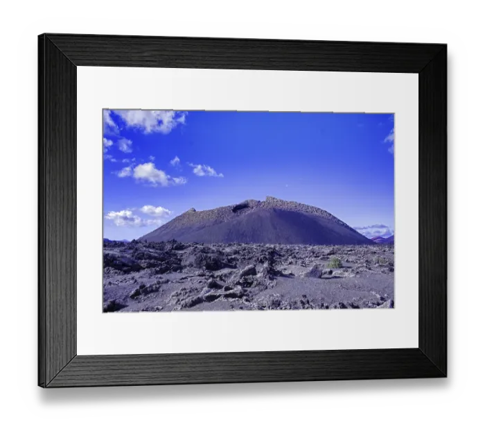 Framed Print : The El Cuervo volcano (Caldera de los Cuervos) rises above a lava field under a clear blue sky Framed Print : The El Cuervo volcano (Caldera de los Cuervos) rises above a lava field under a clear blue sky