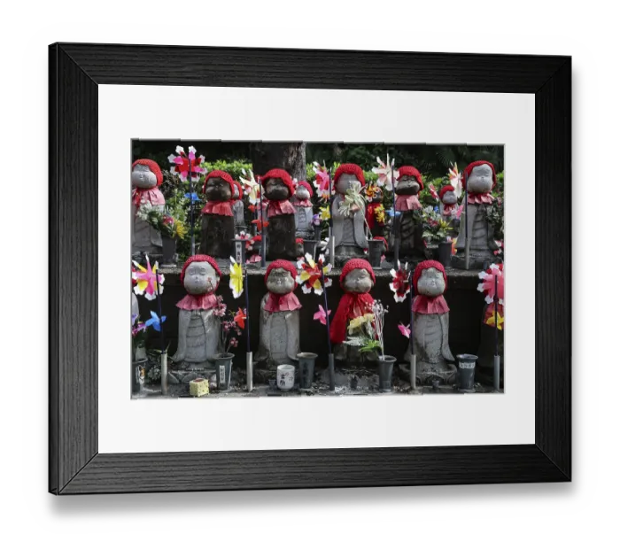 Framed Print : Many jizo statues with red cloths and wind turbines at Zojo-ji Shrine in Minato
