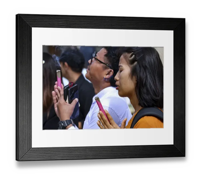 Framed Print : People pray with their eyes closed at the Big Buddha in Kotokuin Temple