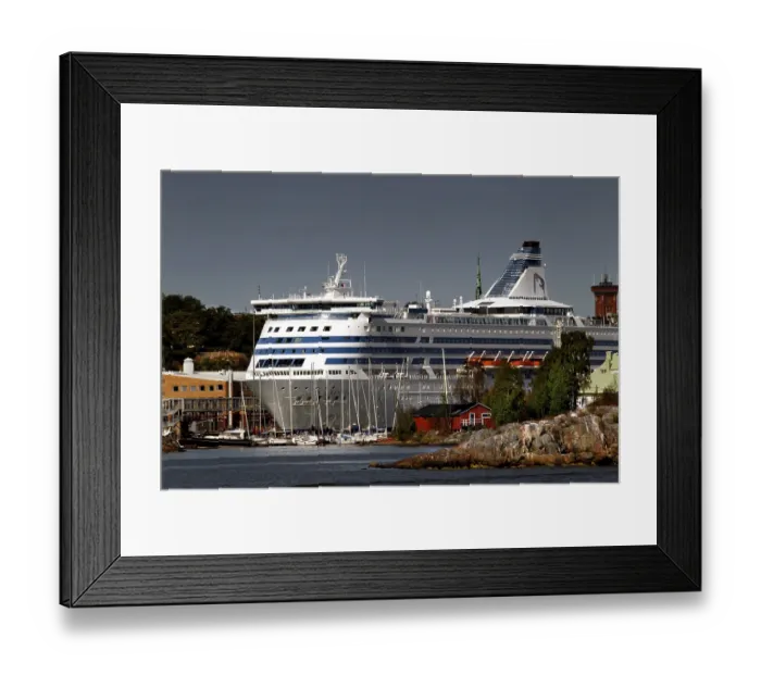 Framed Print : Island in Helsinki with traditional wooden house and large ferry in the background