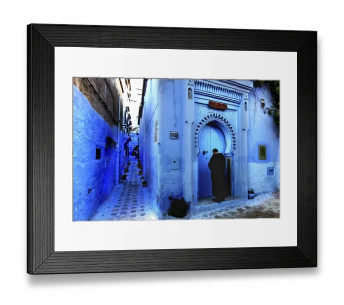 Framed Print : Blue alley with traditional Moroccan gate and a person in the medina of Chefchaouen
