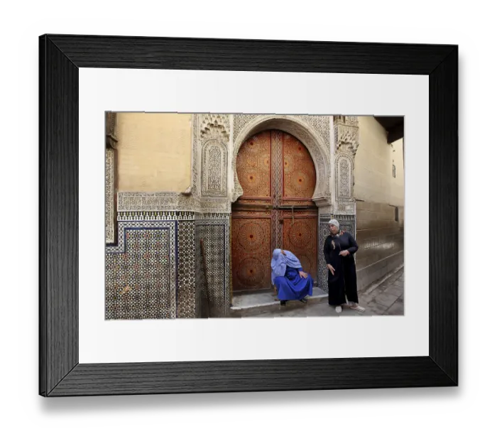 Framed Print : Two men in front of an artfully decorated wooden door with mosaic decoration