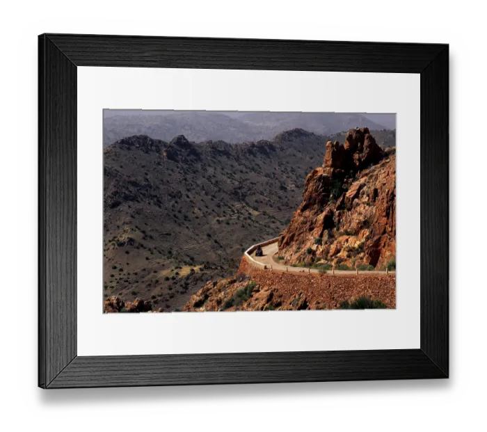 Framed Print : Road snakes through a rocky, dry mountain landscape