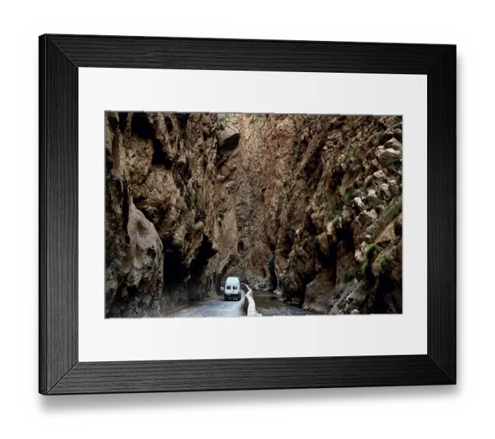 Framed Print : A white vehicle drives through the narrow section of Dades Gorge Framed Print : A white vehicle drives through the narrow section of Dades Gorge