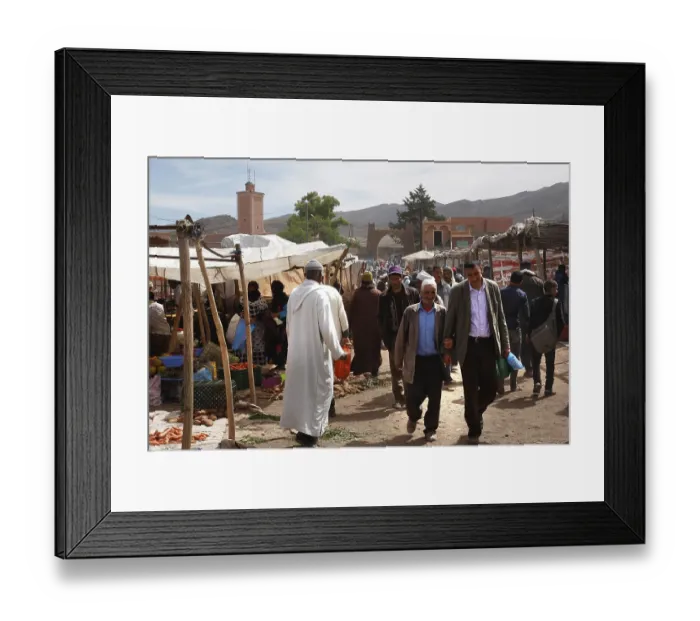 Framed Print : Market scene in Msemrir with people walking along the stalls