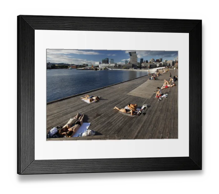 Framed Print : People sunbathe on a deck with a view of the Munch Museum in Oslo Framed Print : People sunbathe on a deck with a view of the Munch Museum in Oslo