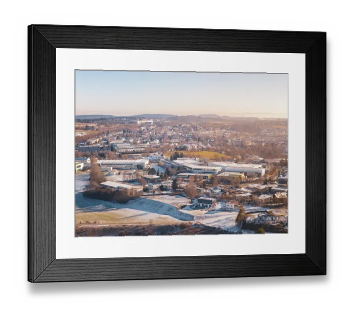 Framed Print : Cityscape in winter with various architectures and hills in the background Framed Print : Cityscape in winter with various architectures and hills in the background