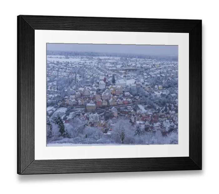 Framed Print : Snowy city landscape with colorful half-timbered houses and winter flair Framed Print : Snowy city landscape with colorful half-timbered houses and winter flair